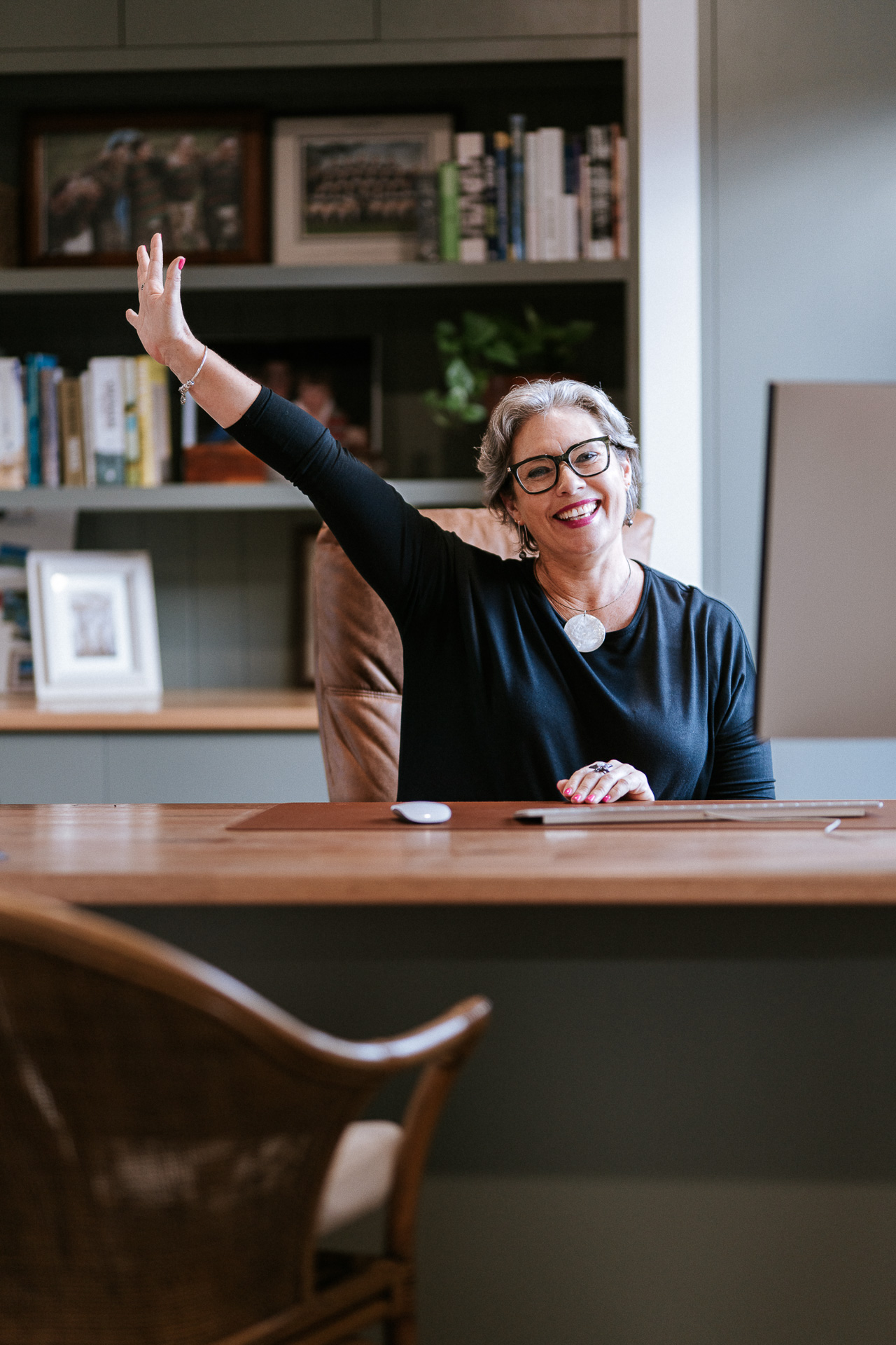 Melissa Meagher speaking energetically at her desk