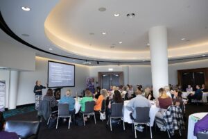 Melissa Meagher presenting to a full room of delegates at the VA Summit