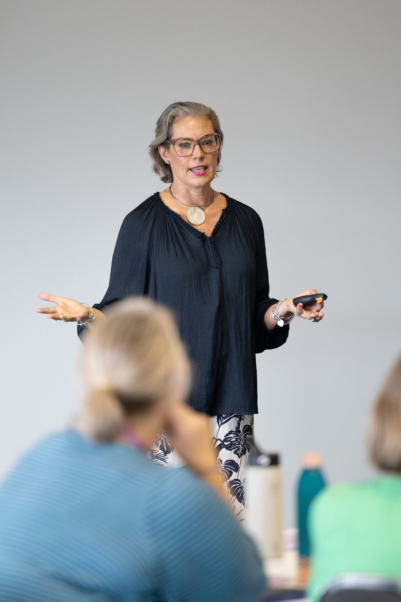 Melissa Meagher speaking energetically at an event